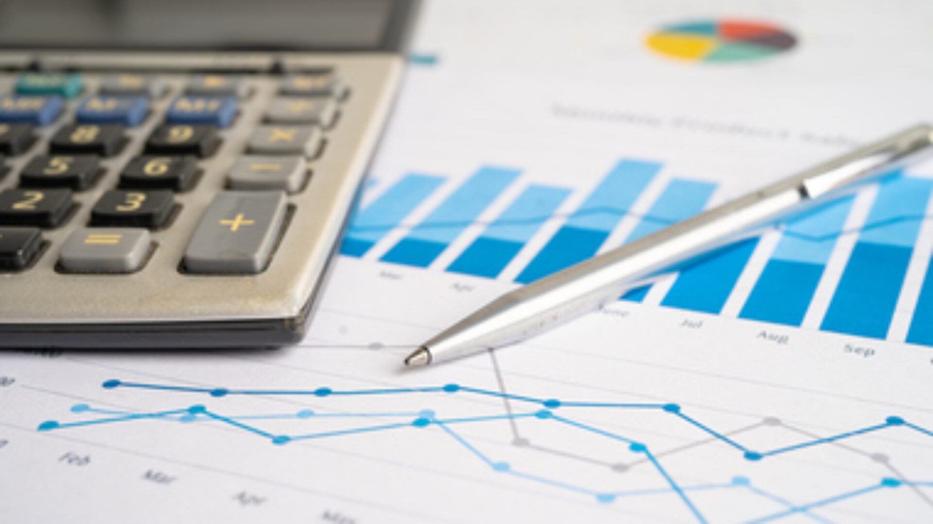 Calculator on chart and graph spreadsheet paper. Finance development, Banking Account, Statistics, Investment Analytic research data economy, Stock exchange trading, Business company concept.