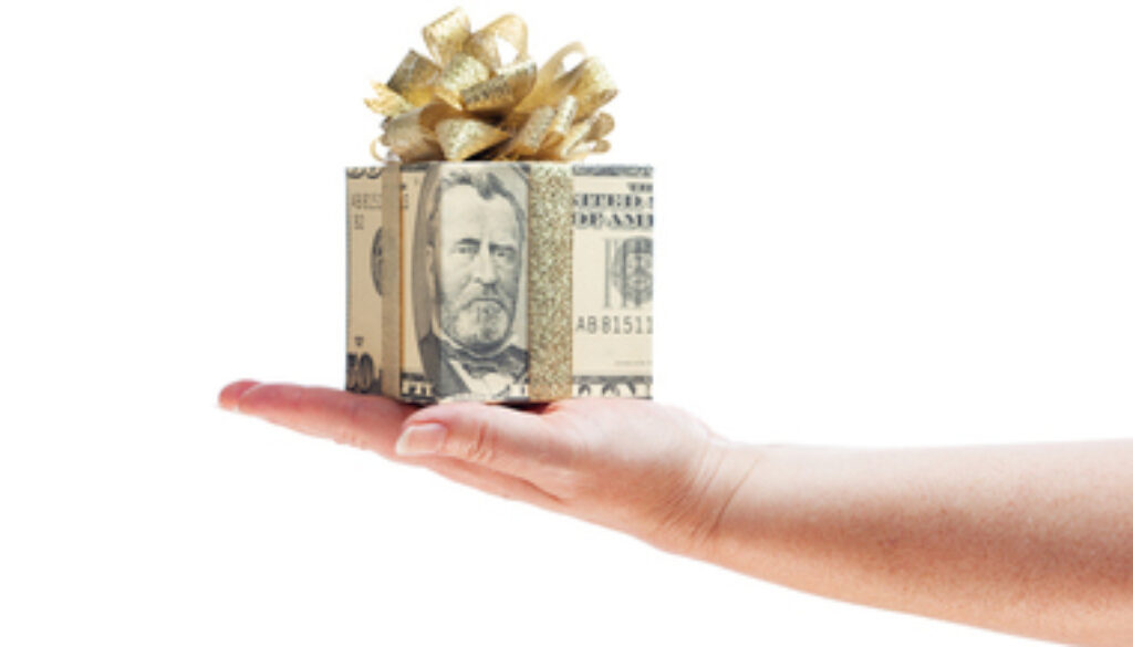 Hand Offering Gift of Money in Gold Ribbon on White