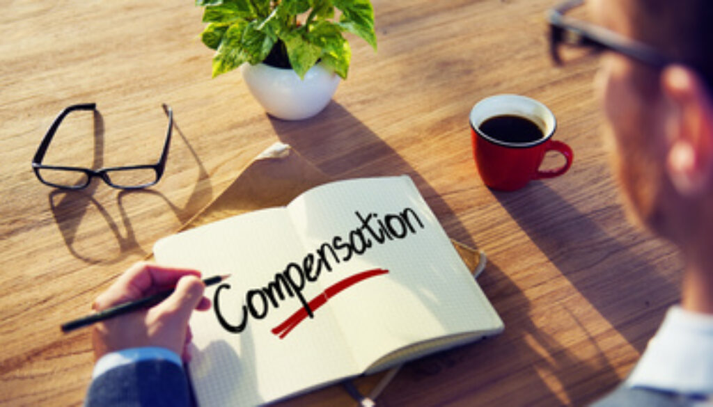 Man with a Note and a Single Word Compensation