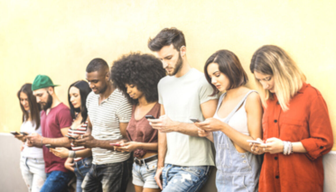 Multiracial friends using mobile smartphone at university coampus - Millenial people addicted by smart phones - Tech concept with always connected millennials on social networks - Bright warm filter