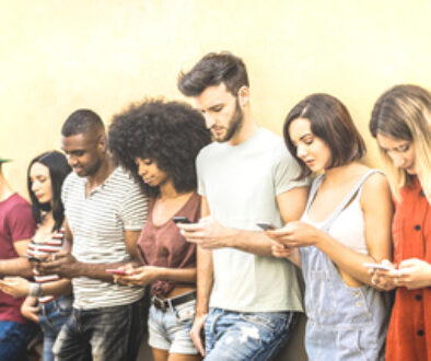 Multiracial friends using mobile smartphone at university coampus - Millenial people addicted by smart phones - Tech concept with always connected millennials on social networks - Bright warm filter