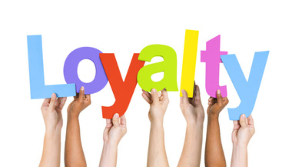 Multi Ethnic People Holding The Word Loyalty
