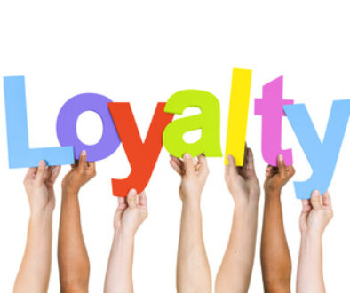 Multi Ethnic People Holding The Word Loyalty