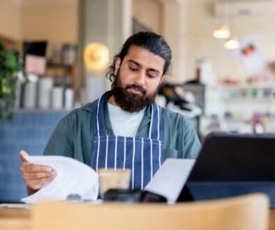 Coffee shop manager checking bills while doing the accountancy