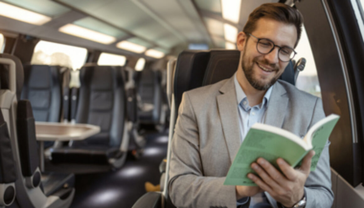 Commuter with Book Traveling With High-speed Train