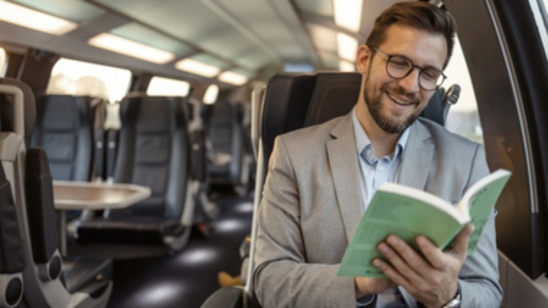 Commuter with Book Traveling With High-speed Train