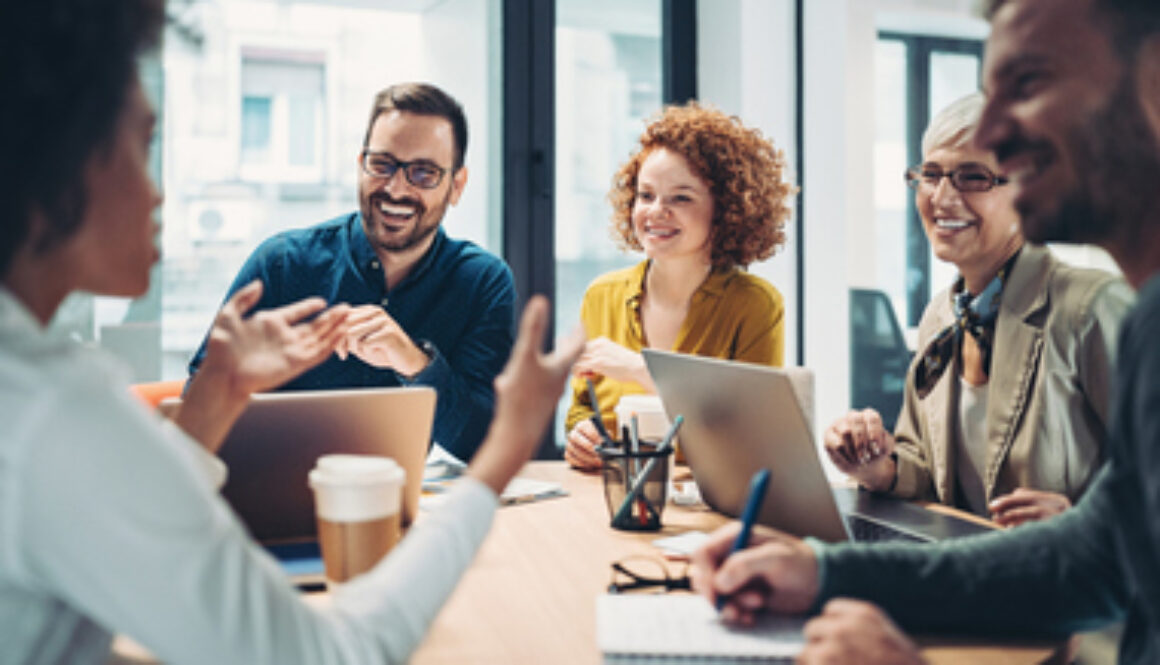 Business people sitting around the table and talking