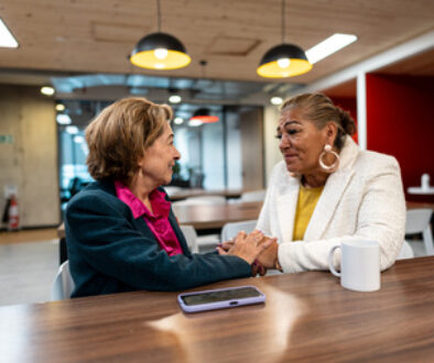 Senior businesswoman consoling coworker in the office