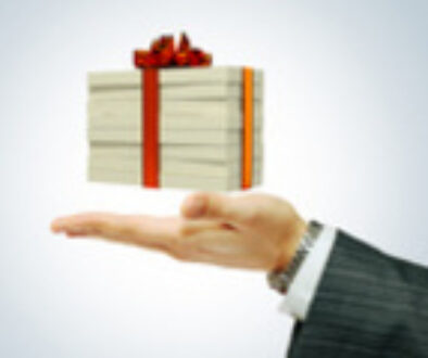 Money concept dollars in the form of a gift box in hand