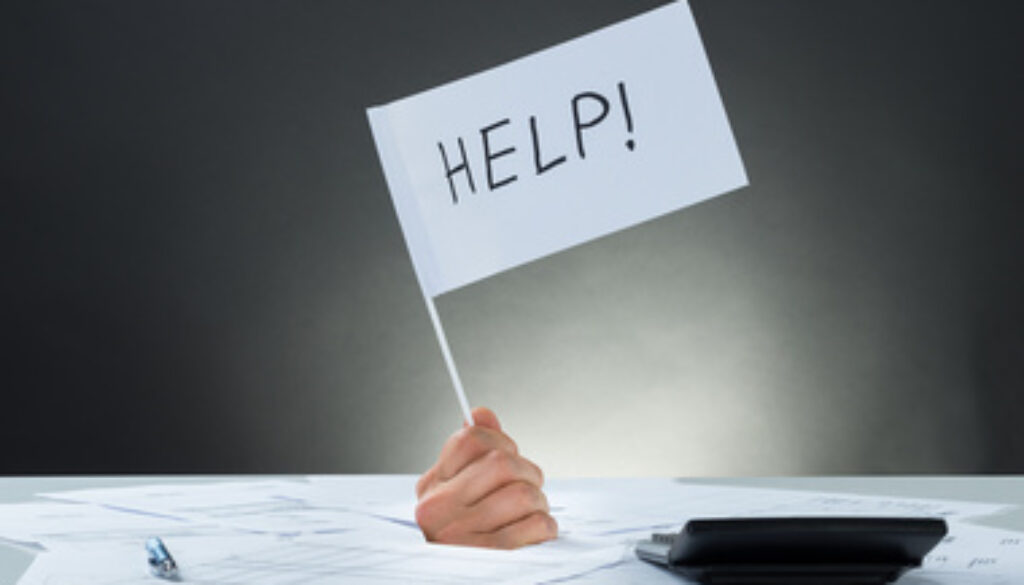 Hand Holding Flag Asking For Help While Emerging From Documents