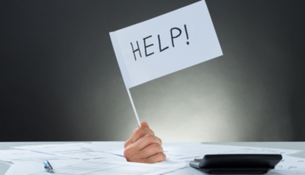 Hand Holding Flag Asking For Help While Emerging From Documents