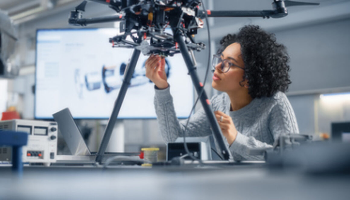 Concentrated Black Female Engineer Writing Code. Developing Software for Modern Drone Control in the Research Center Laboratory. Technological Breakthrough in Flight Industries Concept.