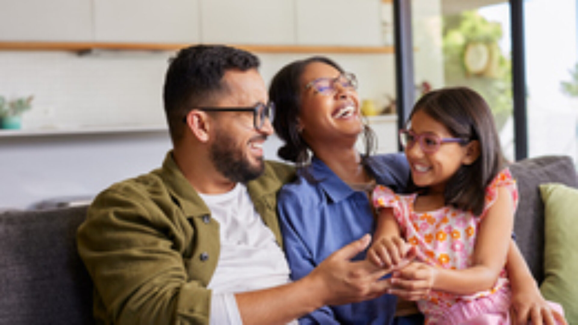 Parents playing with daughter at home