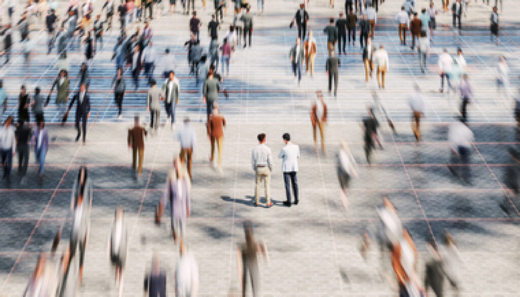 Businessmen on the street standing in crowds of walking people