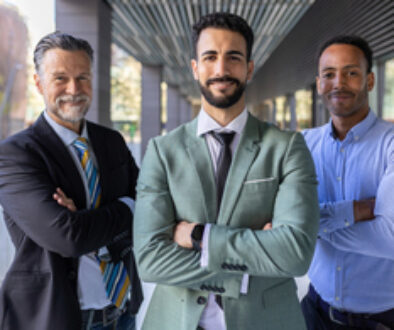 Successful portrait of corporate team of male colleagues looking at camera