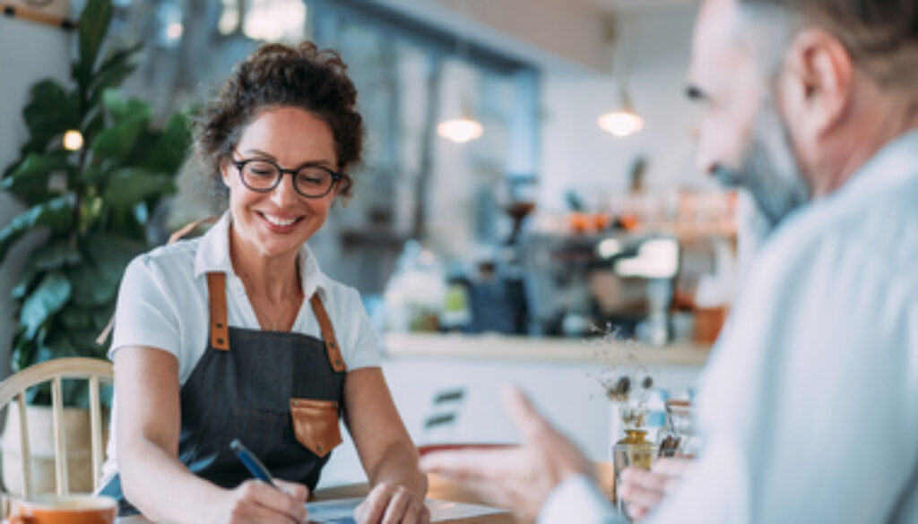 Coffee shop owner meeting with financial advisor.