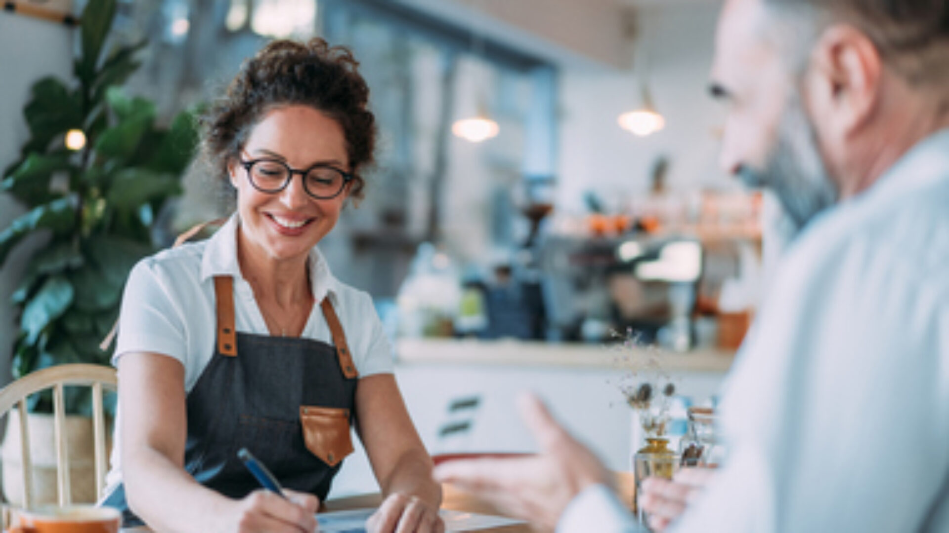 Coffee shop owner meeting with financial advisor.