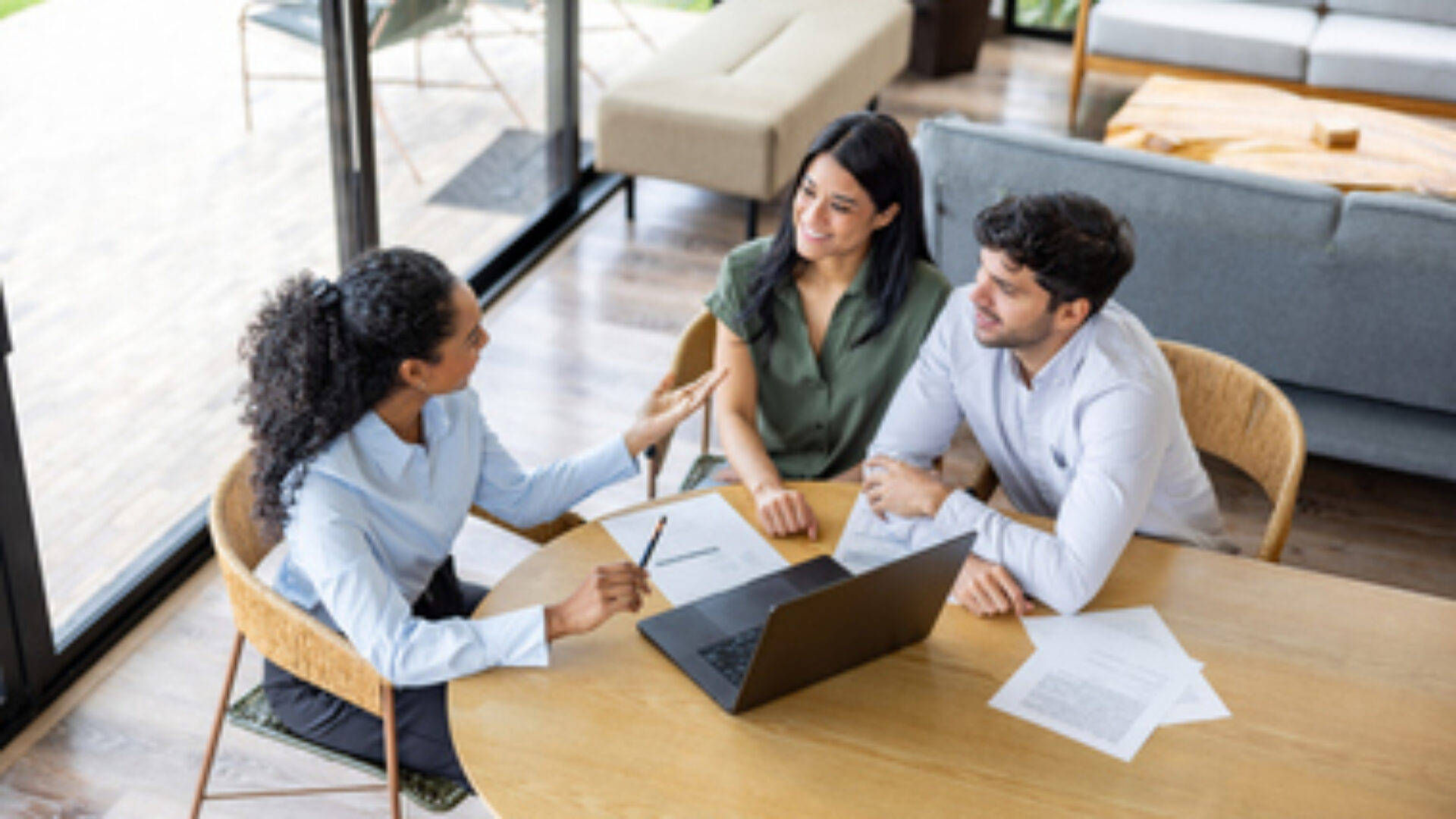 Real estate agent making a sales pitch to a couple buying a house