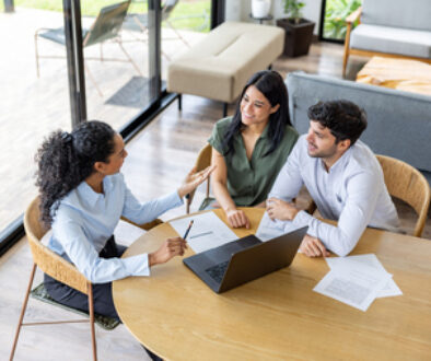 Real estate agent making a sales pitch to a couple buying a house