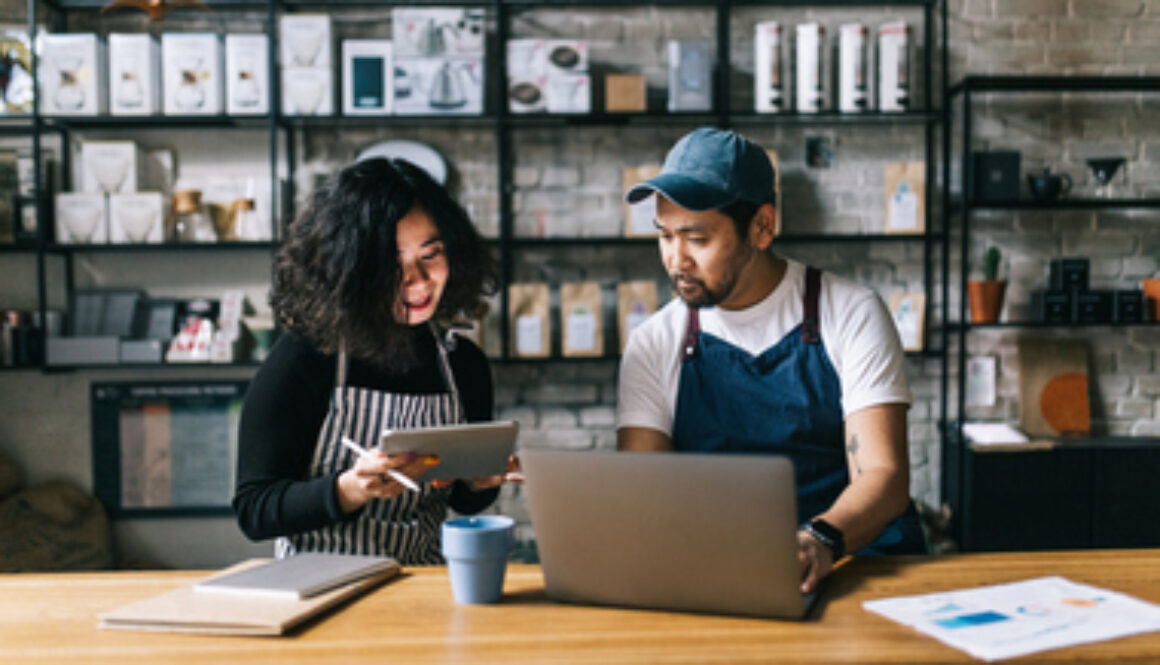 Small business owners working behind cafe counter