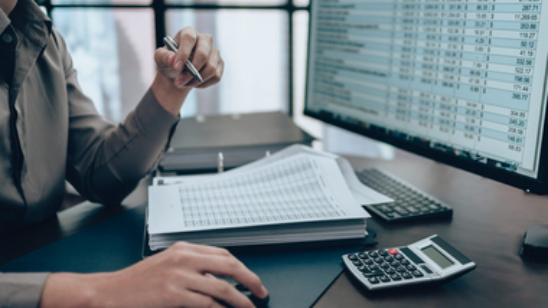 Investors working on desk office and check data cost, balance, profit and currency on monitor screen. Accounting and Financial concept.