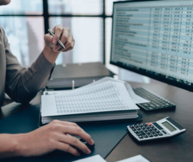 Investors working on desk office and check data cost, balance, profit and currency on monitor screen. Accounting and Financial concept.